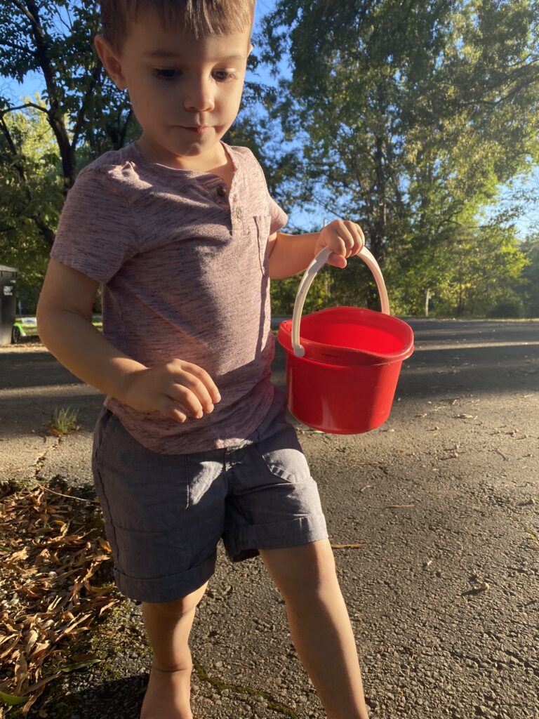 My son looking for fall items doing how fall outdoor activity for toddlers